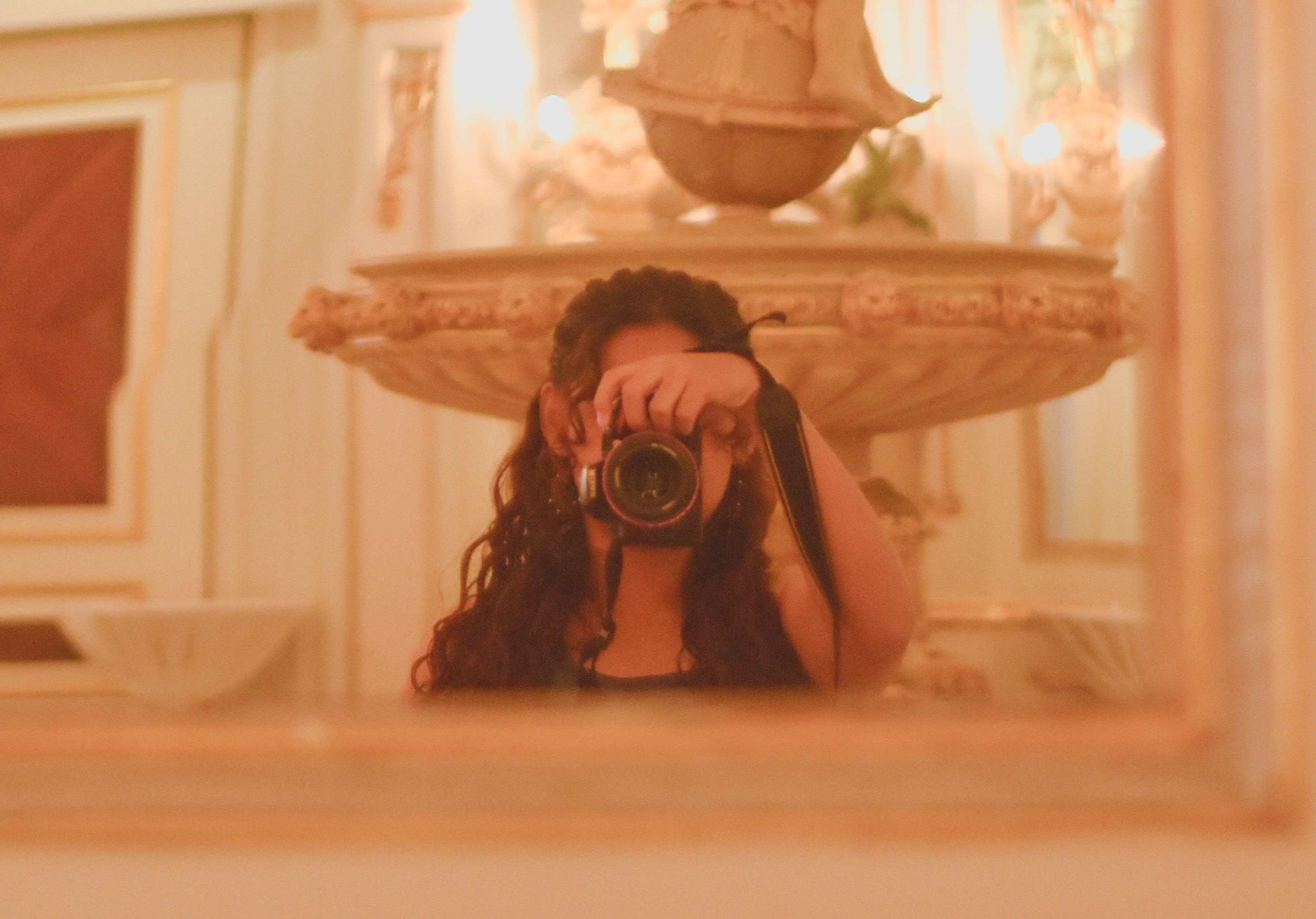 Warm portrait photo of Gera behind a camera